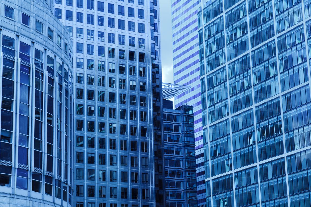 A close-up view of modern skyscrapers with glass facades in a cityscape.