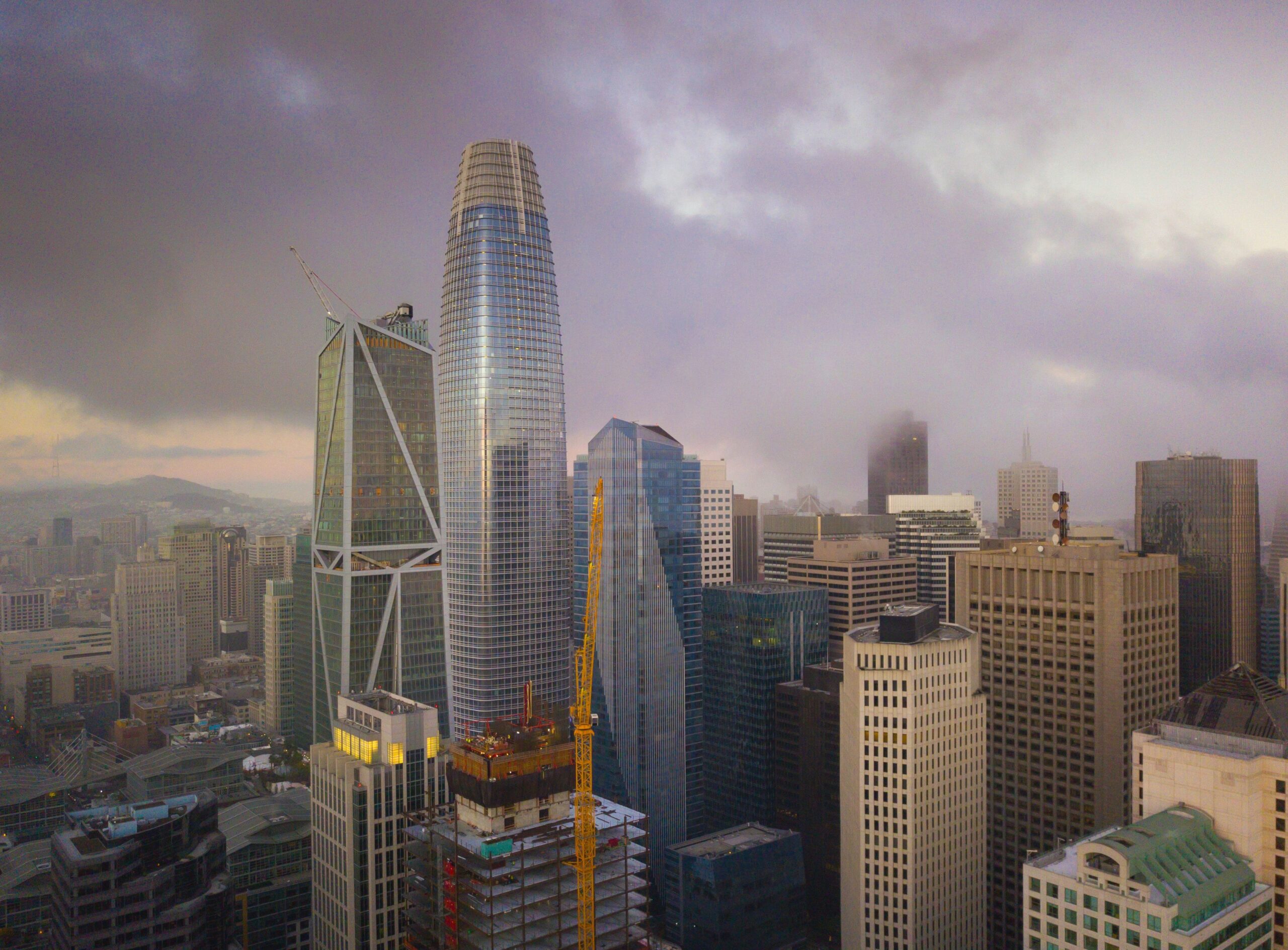 Stunning skyline view of San Francisco's skyscrapers enveloped in fog during twilight
