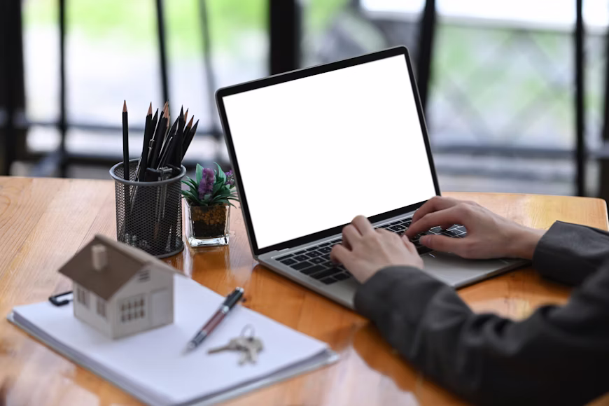 Landlord reviewing property income and expense reports on a laptop with accounting charts